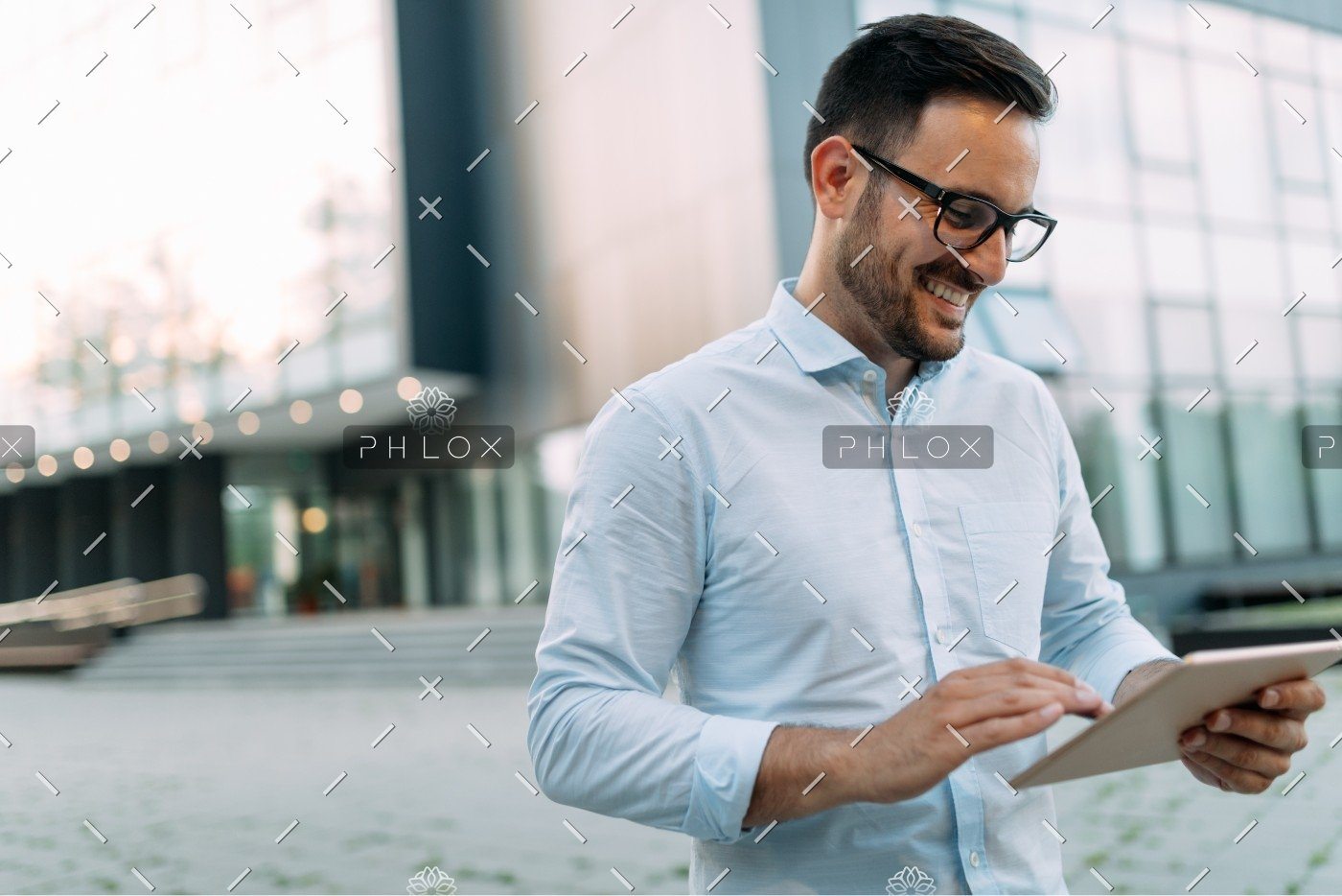 demo-attachment-1482-portrait-of-businessman-in-glasses-holding-tablet-AWVHCJU